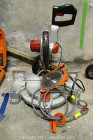 Front view of Craftsman compound mitre saw showing the blade guard, handle, base, and attached power cord.