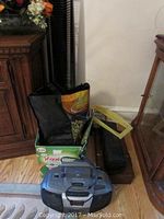 Full view of lot with CD player, CDs, cassettes, storage rack and accessories in cardboard box