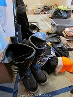 Photo showing multiple ball caps in various colors and brands along with the pair of men's O'Neal motorcycle boots.