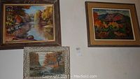 Three original oil paintings displayed grouped on wall: two larger paintings on top, one smaller framed painting below.
