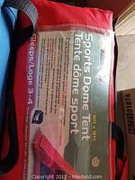 Close-up of the label on the tent's carrying bag showing product features and size.