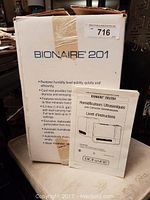 Box of Bionaire 201 humidifier showing product details and owner's manual placed in front.