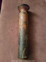 Front view of tall ceramic vase with embossed tree print and multicolor glaze showing brown and green tones.