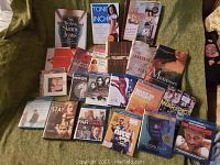 Overview of DVDs and books laid on a green couch showing titles and cover art.