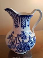 Side view of the blue and white Wheildon Ware ewer showing the floral and geometric design.