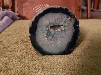 View of the geode's interior crystalline formations and blue concentric rings