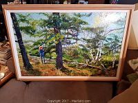 Frontal view of the framed watercolor painting showing the forest scene and person.
