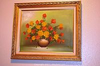 Full view of the framed flower painting showing colorful bouquet and gold ornate frame.