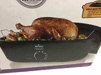 Front view of the box showing the Rival 16 Quart self-basting roaster oven with cooked turkey illustration and temperature control dial.