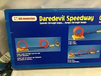 Box side showing Daredevil Speedway looping jumps and track features in blue and red plastic