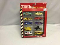 Original boxed set of 10 Tonka diecast vehicles in clear plastic display box with red and black border.