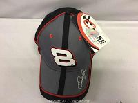 Full view of the gray and black NASCAR ball cap with red trim, showing embroidered number 8 on front and Dale Jr signature on brim, with hang tag attached.