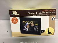 Front view of the boxed ultra slim 7 inch Digital Decor digital picture frame with packaging visible showing branding and product features.