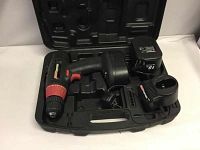Colman 18 Volt Powermate cordless drill, extra battery, charger, inside molded plastic case showing overall condition and components.