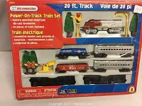 Front photo of the Kid Connection Power-On-Track train set in original box showing the engine, rail cars, and accessories arranged clearly inside.
