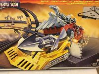 Close-up of box artwork featuring yellow bulldozer-style and red harvester-style battle vehicles and looped race track.