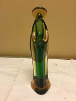 Full front view of the vintage art glass Madonna statue showing green interior with gold accents on hands and halo.