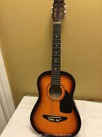 Full front view of the sunburst 3 quarter size acoustic guitar by Kay showing the body, fretboard, and headstock.