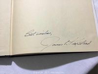 Close-up of signature page inside the book showing James Keirstead's handwritten signature with inscription "Best wishes".
