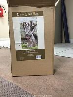 Closed original cardboard box labeled New Creative Angel Statuary with image of angel holding wreath.