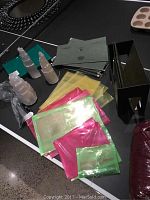 Pair of natural salt rock bookends with colorful plastic folders in red, yellow, and green, plus green wire file hangers and black metal file folder holder on black surface.