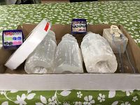 Three large translucent white healing stones, roughly cylindrical and textured, displayed in box.
