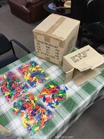 Closed cardboard case box with sealed contents containing 4 boxes of toys on a table