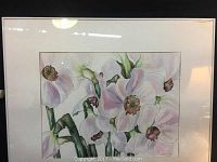 Framed watercolour painting showing white flowers with green stems under glass.