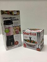 Photo of the boxed Hamilton Beach Personal Creations Blender and Starfrit vegetable steamer boxes