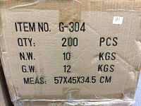 Photo shows the unopened cardboard shipping box with label details: Item No. G-304, quantity 200 pieces, net weight 10 kgs, gross weight 12 kgs, measurements 57x45x34.5 cm.