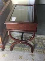 Side view of the Bombay Co. side table showing wood legs and glass top.