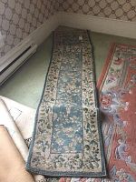 Green runner laid out flat showing floral rectangular pattern