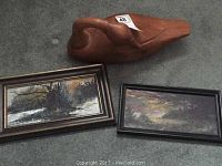 Photo showing both framed oil paintings on board and the carved wooden goose sculpture together on the floor.