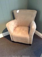Front view of the beige micro suede arm chair showing overall condition and design