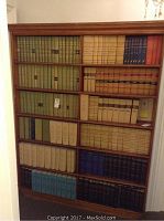 Front view showing oak bookshelf filled with books