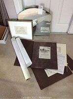 Lot showing four sets of prints rolled and unrolled with covers, small framed sketch, curved mirror, and some paper paperwork.