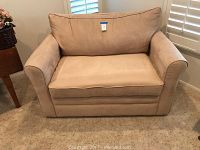 Front view of beige ultra suede loveseat sofa showing cushioned seat, back, and armrests.