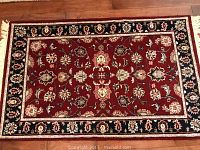 3.5 x 5.5 red, navy, and cream area rug with floral pattern taken from above