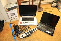 Wide view showing Toshiba laptop, Kodak box, power strip and cords