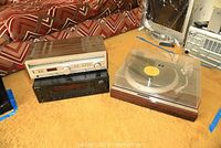 Three components arranged side by side on carpeted floor