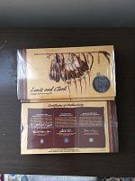 Front and back of sealed Lewis and Clark certificate envelope showing artwork and embedded silver medal
