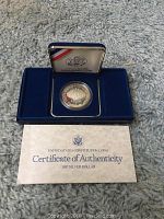 1987 US Constitution Silver Dollar in blue case with certificate of authenticity shown
