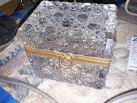 Closed pressed cut glass hinged box with brass-tone rim and ring clasp