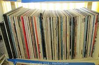 Shelf of vinyl LP records arranged vertically on a rack