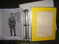Three-ring binder open showing Ken Curtis stock photo signed and NBC News typed letter mounted on yellow backing