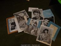 Top down view of the lot showing various autographed photos and documents including framed Rex Allen Jr. photo, Peggy Stewart signed photo, and printed movie posters.