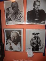 Photo showing the full set of four signed black and white celebrity photos on an orange wall: Harry Morgan, Gale Gordon, Carroll O'Connor, Randolph Scott.