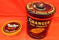 Two tobacco tins, one large Granger Pipe Tobacco tin and one smaller Three Nuns Tobacco tin.