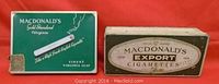 Two vintage MacDonald's tobacco tins, one green with cigarette image and gold 50 marking, one rectangular with Export Cigarettes label, showing wear and scratches