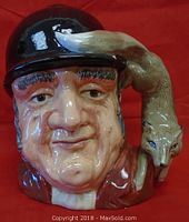 Front view showing the face of the man and fox on hat.